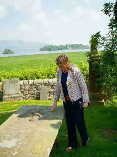 Sarah looking at a gravestone