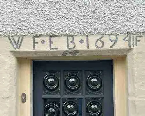 Old doorway with year and property owners' initials in Falkland village