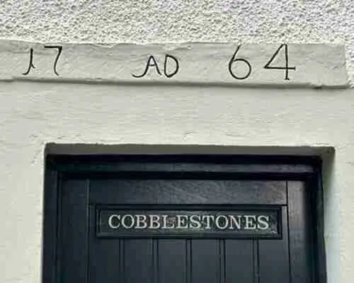 Old doorway with year and property owners' initials in Falkland.