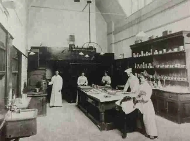 A kitchen from a grand estate with a cook and kitchen maids